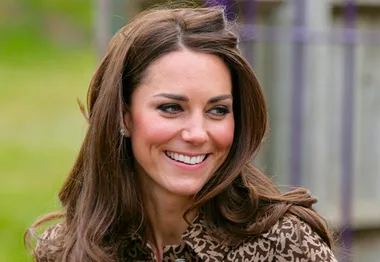 I don’t know who this person is, but it's a woman with long brown hair smiling outdoors, wearing a patterned outfit.