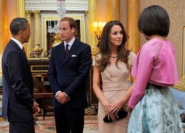 Prince William and Catherine meet with Barack and Michelle Obama at a formal event in an elegantly decorated room.
