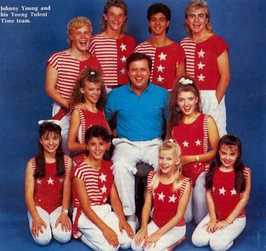 "Group photo of Johnny Young with the Young Talent Time team in matching red and white outfits."