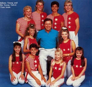"Group photo of Johnny Young with the Young Talent Time team in matching red and white outfits."