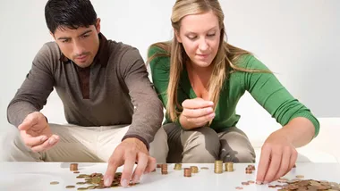 couple with money, getty images 