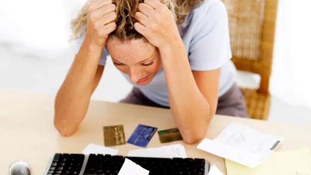 distressed woman with credit cards