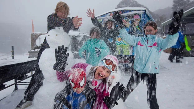 Family plays in the snow