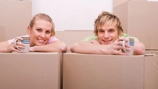 young couple with cardboard boxes, thinkstock