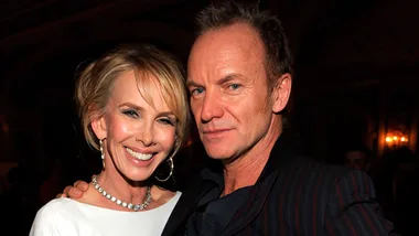 A couple posing together at an event, warmly smiling at the camera.