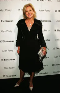 Woman in a black dress on a red carpet with Electrolux and Alex Perry logos in the background.