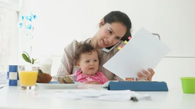 Mum on the the phone with baby on lap