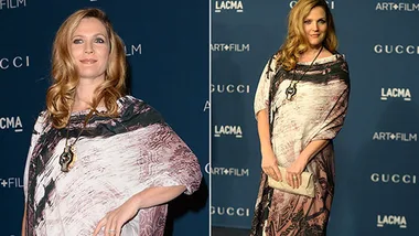 Drew Barrymore at a LACMA Art + Film Gala red carpet in a patterned dress, smiling and posing for photos.
