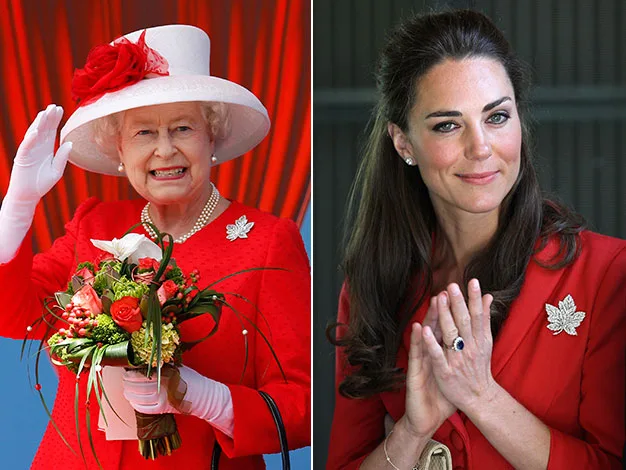 Two women in red outfits. One with a white hat and bouquet, smiling and waving; the other with long dark hair clasping hands.