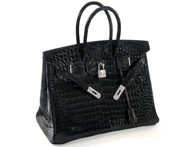 A black crocodile leather handbag with silver hardware and a lock on the front.