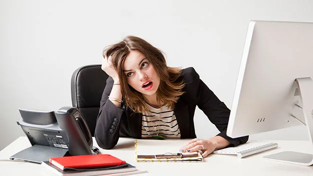 Woman looking stressed at her desk