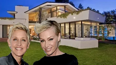 Two individuals in front of a modern house with large windows, surrounded by greenery, during twilight.