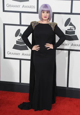 Person in a long black dress with a lilac bob hairstyle on the red carpet at the Grammy Awards.