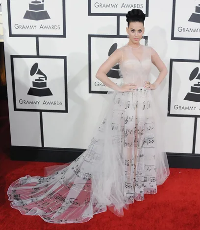 "Person in a white musical notes gown at the Grammy Awards red carpet."