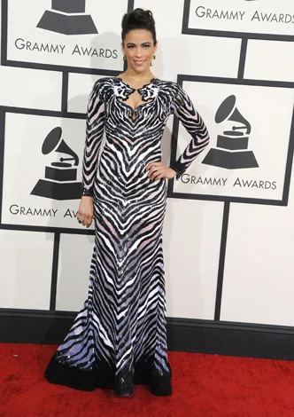 Woman in zebra-patterned gown posing on the red carpet at the Grammy Awards.
