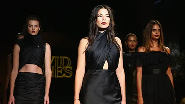 Models in elegant black dresses walking the runway at David Jones 2014 launch event.