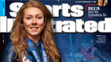 Young woman athlete in a blue outfit smiling, wearing Olympic medals on Sports Illustrated cover.