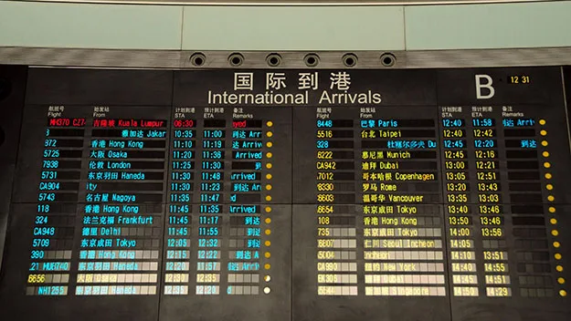 "Airport arrival board displaying flight MH370 details among other flights."