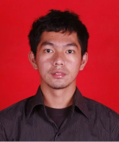 Person with short dark hair, wearing a dark striped shirt, against a red background.