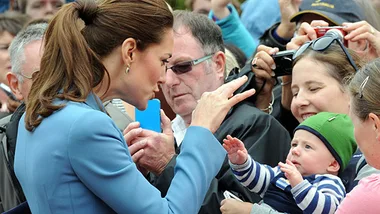 Kate Middleton playing with baby