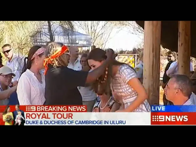 A person embraces the Duchess of Cambridge during a royal tour in Uluru, Australia.