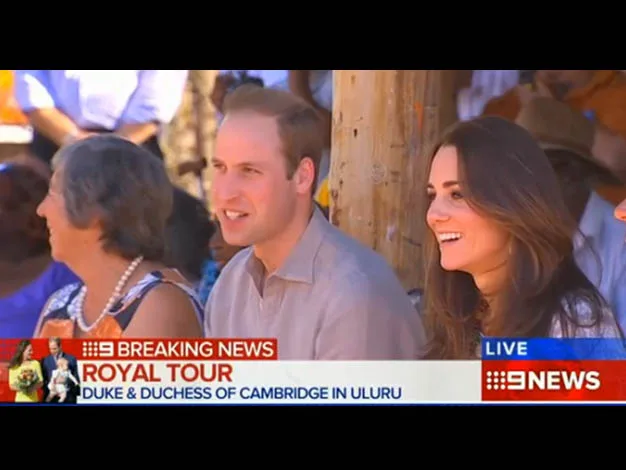 Duke and Duchess of Cambridge sitting outdoors, smiling, during a royal tour in Uluru, captured by 9 News.