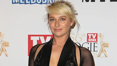 Asher Keddie at the TV Week Logie Awards, wearing a black gown, standing in front of a media wall.
