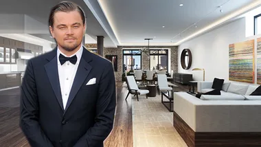 A person in a tuxedo stands in a modern living room with a sofa and dining set, featuring contemporary art on the wall.