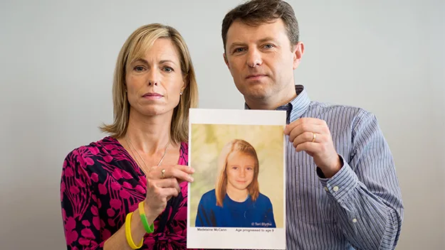 Parents hold an age-progressed photo of Madeleine McCann, missing at age 3, in an appeal for information.