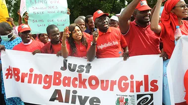 Protesters holding a "#BringBackOurGirls" banner, advocating for the return of kidnapped Nigerian schoolgirls.