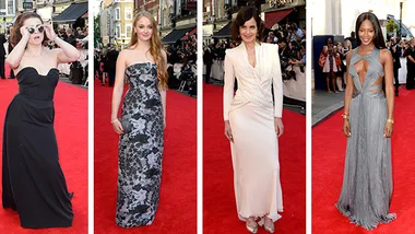 Women in elegant gowns walking on a red carpet at the BAFTAs, surrounded by photographers and onlookers.