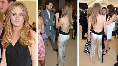 Woman in a stylish backless top and silver pants at a social event, engaging in conversation with attendees.