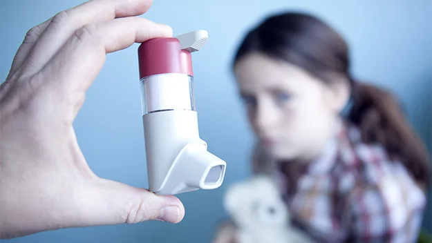 asthma puffer and child