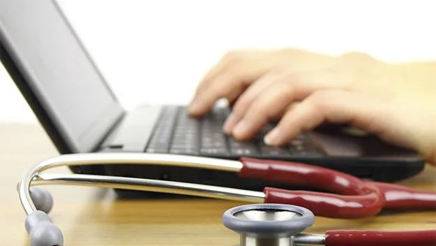 worker with laptop and stethoscope