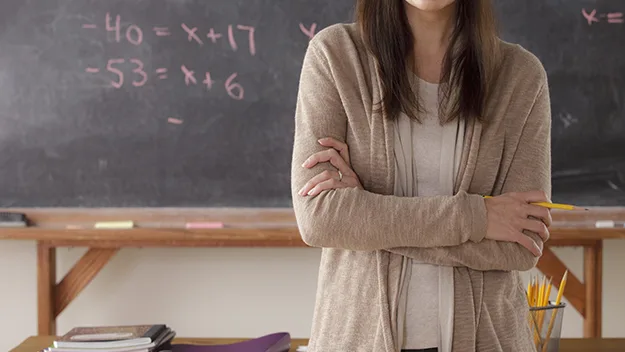 teacher in front of blackboard, stock image