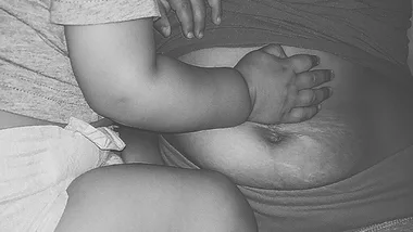 Baby's hand touching a woman's stomach with visible stretch marks.