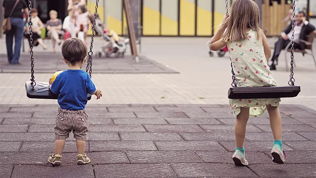 Children playing on swings