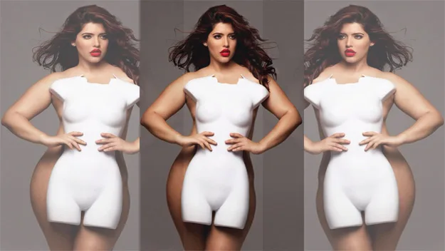 A woman poses confidently in a fitted white outfit with cut-out detailing, showcasing her curves and red lipstick.