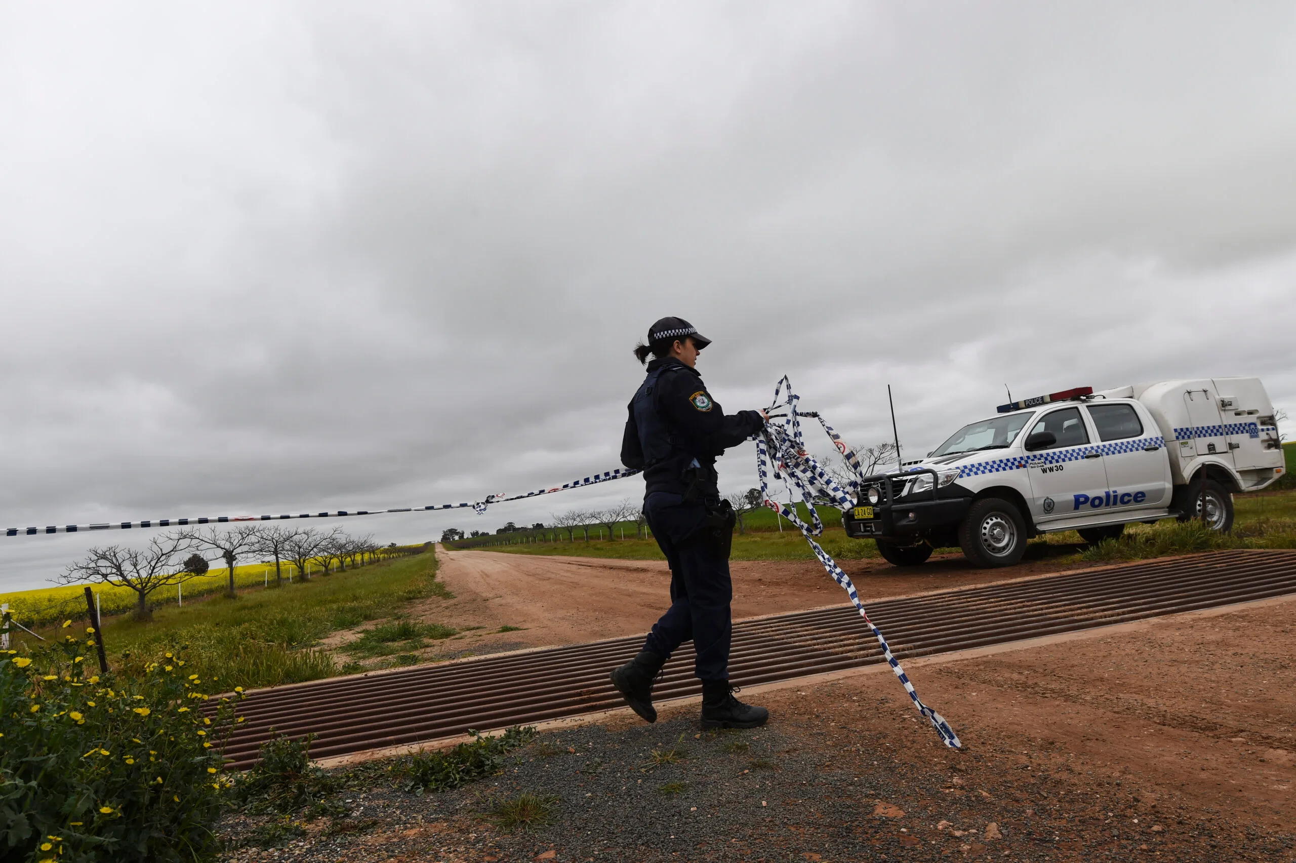 Police block the entrance to a rural farmhouse near Lockhart