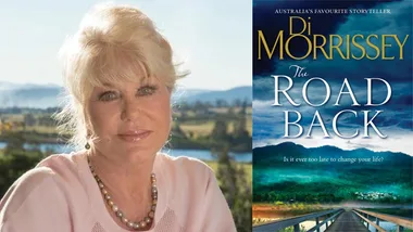 Di Morrissey outdoors with "The Road Back" book cover displayed beside her.