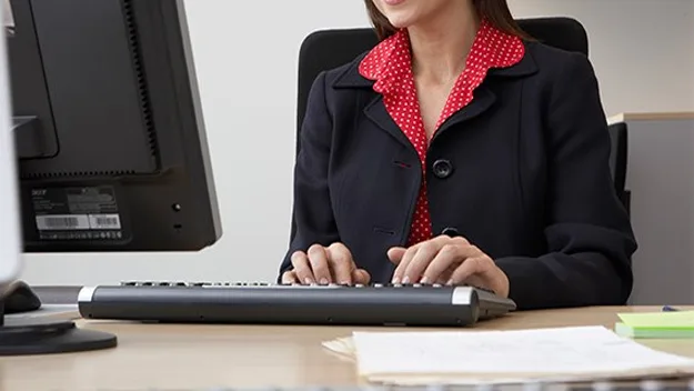 woman typing at computer, stock image