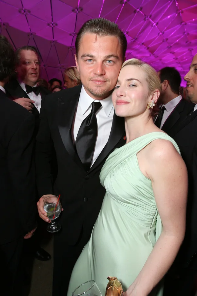 Couple in formal attire poses at an event with a purple-lit dome ceiling.