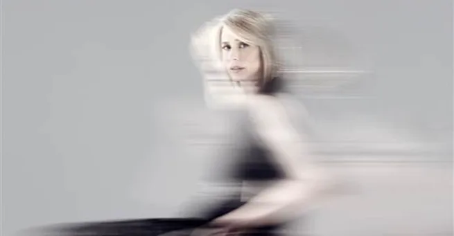 A woman in a wheelchair, with a blurred motion effect, symbolizing empowerment and dynamic strength.