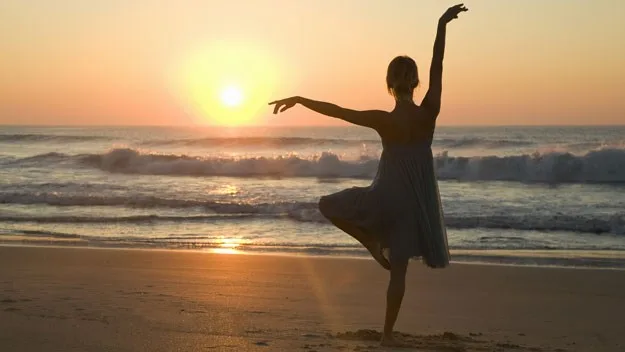 female silhouette sunset beach