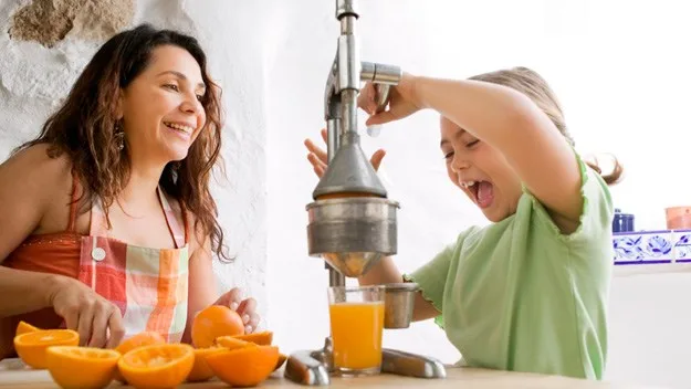 mother and daughter juicing together