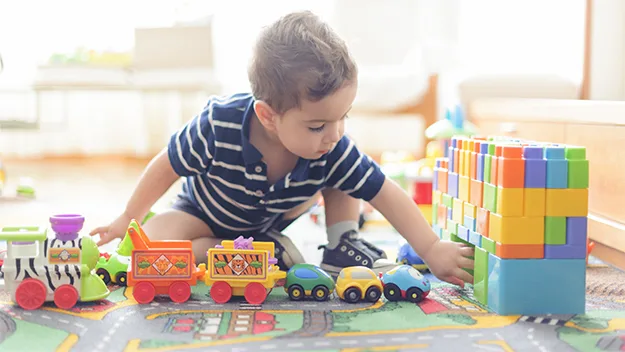 Baby boy playing with toys