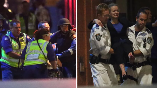 Police and paramedics evacuate hostages during the Sydney hostage crisis, aiding visibly distressed individuals.