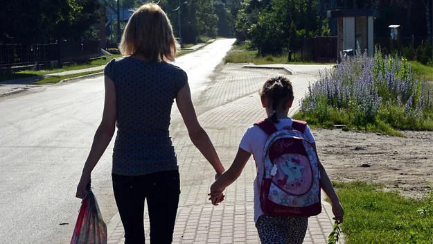 Mother and daughter holding hands