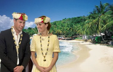 A couple in floral hats stands on a tropical beach with palm trees and blue sky in the background.