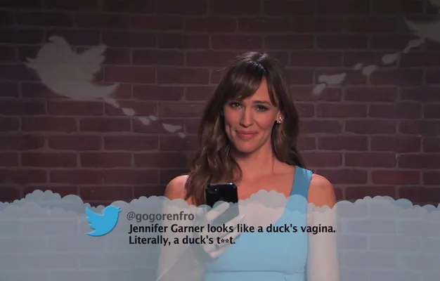 Woman in a blue dress smiling, holding a phone, with a tweet overlay on a brick background with Twitter logos.